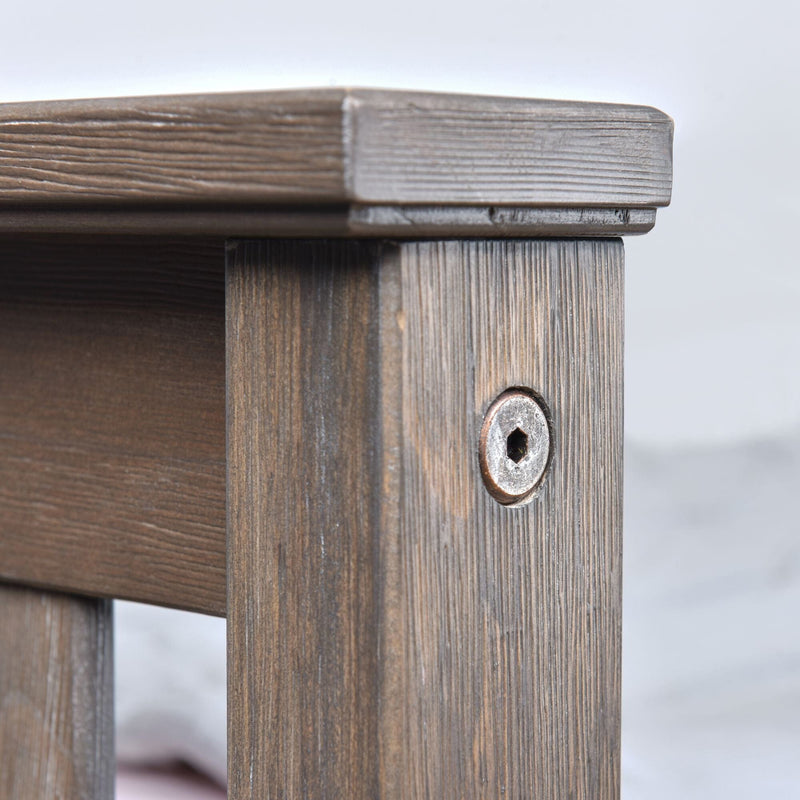 Close-up of rustic wooden furniture corner showing weathered wood grain and hex bolt screw on a stained pine bedside table joint detail