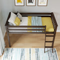Children's dark wood loft bed with ladder, yellow bedding, patterned pillows and blue knit throw, hardwood floor, striped rug and framed wall art