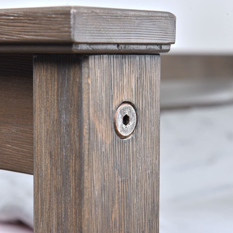 Close-up of rustic wooden furniture leg with recessed hex bolt fastener and textured wood grain