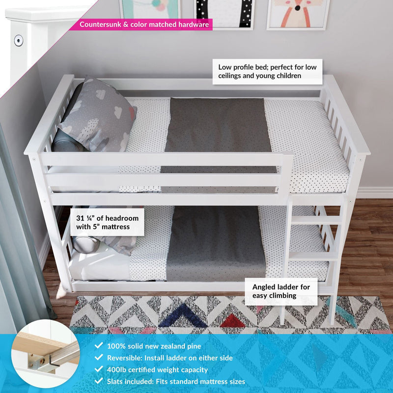 White low-profile wooden bunk bed for kids with angled ladder, dotted bedding, solid New Zealand pine construction, reversible ladder and 400 lb capacity