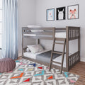 Gray wooden bunk bed in a modern children's bedroom with polka dot bedding, pastel cloud pillows, animal wall art, light blue curtains and a colorful geometric rug