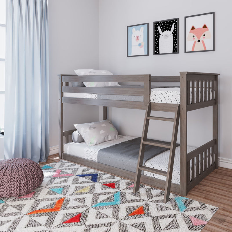 Gray wooden bunk bed in a modern children's bedroom with polka dot bedding, pastel cloud pillows, animal wall art, light blue curtains and a colorful geometric rug