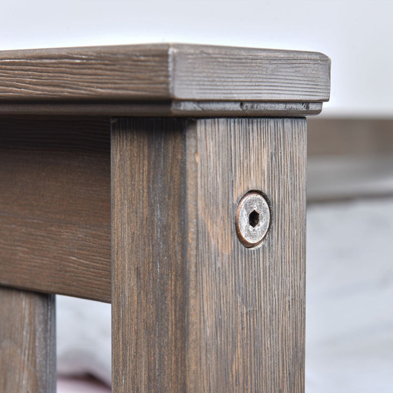 Close-up of a rustic wooden table corner showing detailed wood grain texture, plank joint and recessed hex screw