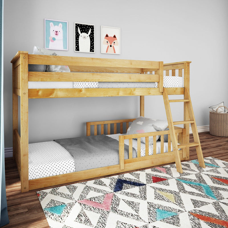 Natural wood twin-over-twin bunk bed with ladder in modern kids' bedroom, polka-dot bedding, cloud pillow and colorful geometric rug