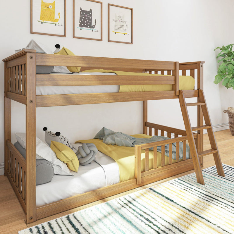Solid wood bunk bed with ladder in children's bedroom, yellow bedding, cat print wall art, striped rug and potted plant