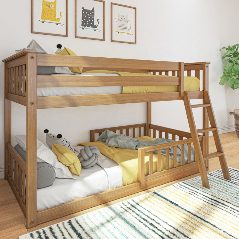 Wooden bunk bed in a bright kids' bedroom with ladder, yellow bedding and pillows, lower bed guardrail, playful framed cat wall art, striped rug and potted plant