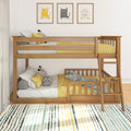 Modern wooden twin-over-twin bunk bed with ladder in a children's bedroom, yellow bedding, decorative pillows, cat wall art and striped rug