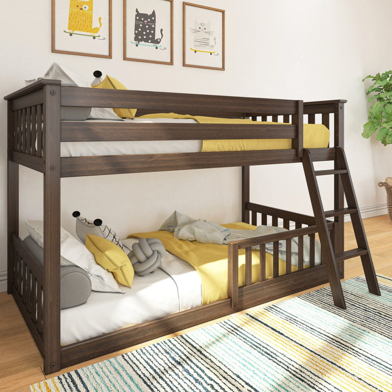 Solid wood twin-over-full bunk bed with angled ladder in children's bedroom, dark walnut finish, yellow bedding, playful cat wall art and striped rug