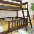 Solid dark wood bunk bed with angled ladder, yellow bedding and throw in a styled kids' bedroom with striped rug and potted plant