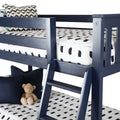 Navy blue wooden twin bunk bed with ladder in kids' bedroom, black-and-white dotted bedding and plush teddy bear