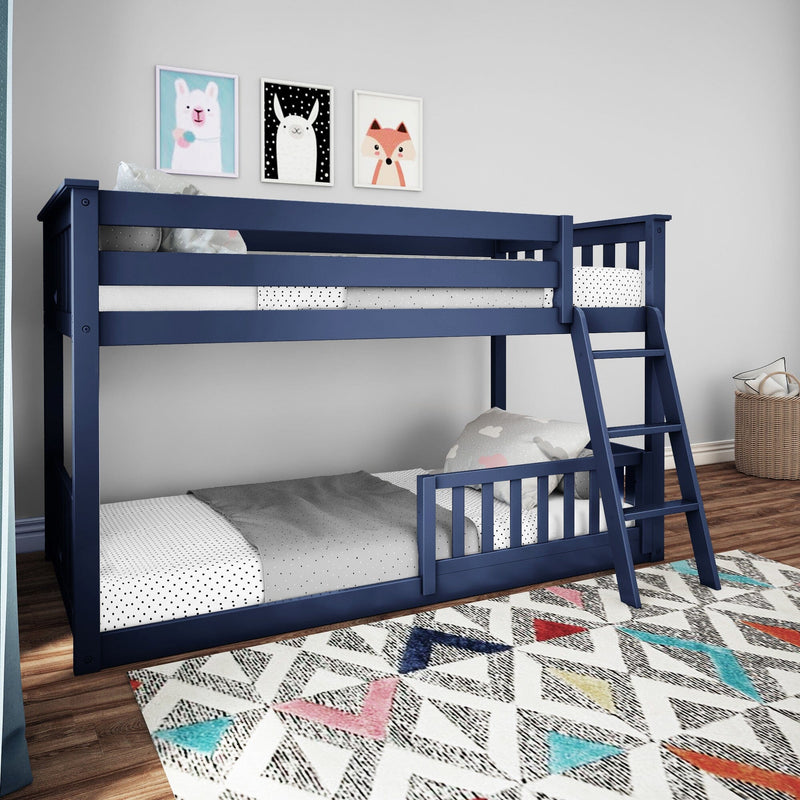 Modern navy blue wooden twin-over-twin bunk bed with ladder and safety rails in a children's bedroom with polka-dot bedding, colorful geometric rug, and animal wall art