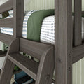 Close-up of gray wooden bunk bed ladder and guardrail with green blanket, blue striped throw and cross-pattern white sheets in a modern kids' bedroom with turquoise record player
