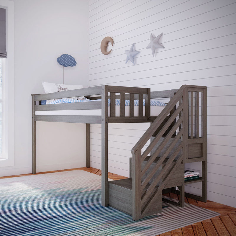 Gray wooden kids loft bunk bed with staircase, white shiplap accent wall featuring moon and star decor, blue striped bedding and rug