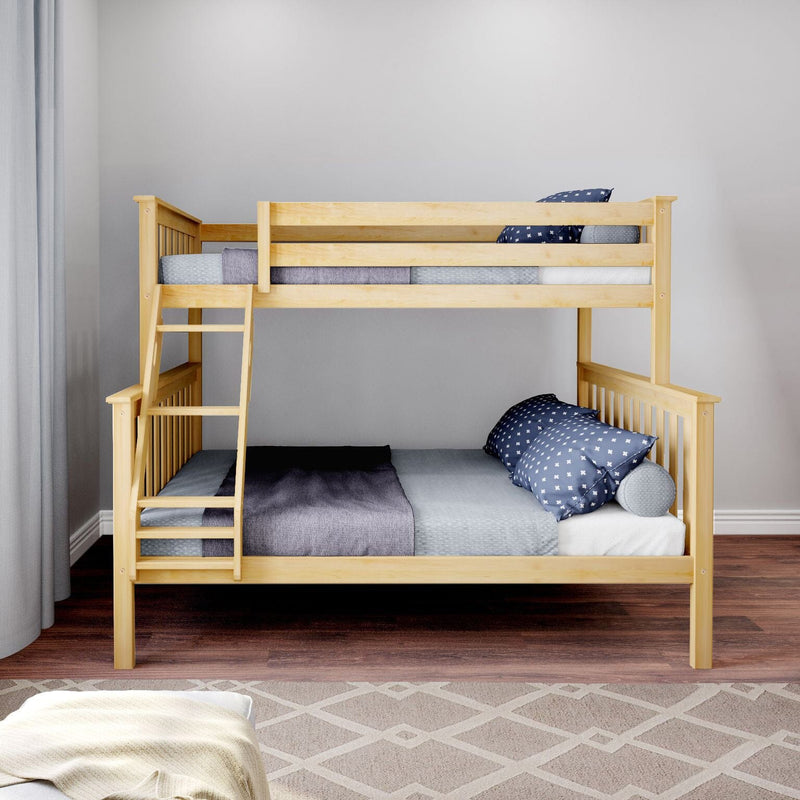 Light natural wood bunk bed with ladder in modern children's bedroom, navy star-pattern pillows, gray bedding, hardwood floor and neutral geometric rug