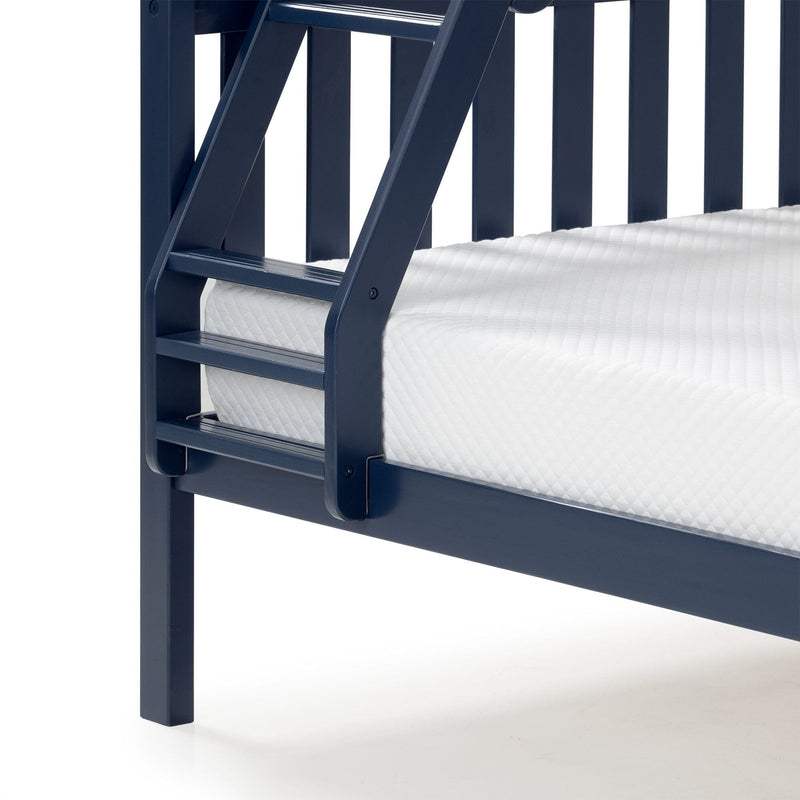 Close-up of navy blue wooden bunk bed ladder and white quilted mattress edge on modern kids' bunk bed frame