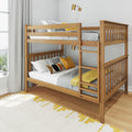 Natural wood bunk bed with ladder, gray bedding and mustard yellow accent pillows in a modern kids' bedroom with gray curtains and brass wall sconce