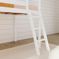 White loft bed with ladder and blush pink mattress against shiplap wall in modern kids' bedroom with hardwood floor