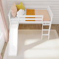 White wooden kids' loft bed with slide and ladder, pink and mustard pillows, cloud cushion and orange blanket in bright Scandinavian-style nursery