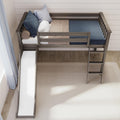 Top-down view of gray wooden loft bed with built-in slide and ladder, blue pillows and bedding in modern kids' bedroom