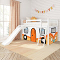 Bright children's bedroom with a white loft bed featuring a slide and ladder, orange camper-themed play tent panels underneath, decorative bunting, large window, and natural wood flooring