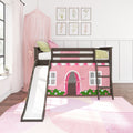 Dark wood girls loft bed with white slide and pink playhouse curtain, canopy, ladder and framed floral wall art in a bright kids' bedroom