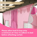 Close-up of a pink children's bed canopy curtain with hook-and-loop (velcro) strips attached to a wooden bed frame, showing curtain panels and clear window pockets