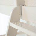Close-up of white wooden slatted chair with curved backrest in a minimalist modern nursery or home interior