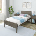 Modern cozy bedroom with gray wood bed frame, pastel blue and lavender bedding, matching nightstands, blue lamps, framed wall art and potted plant