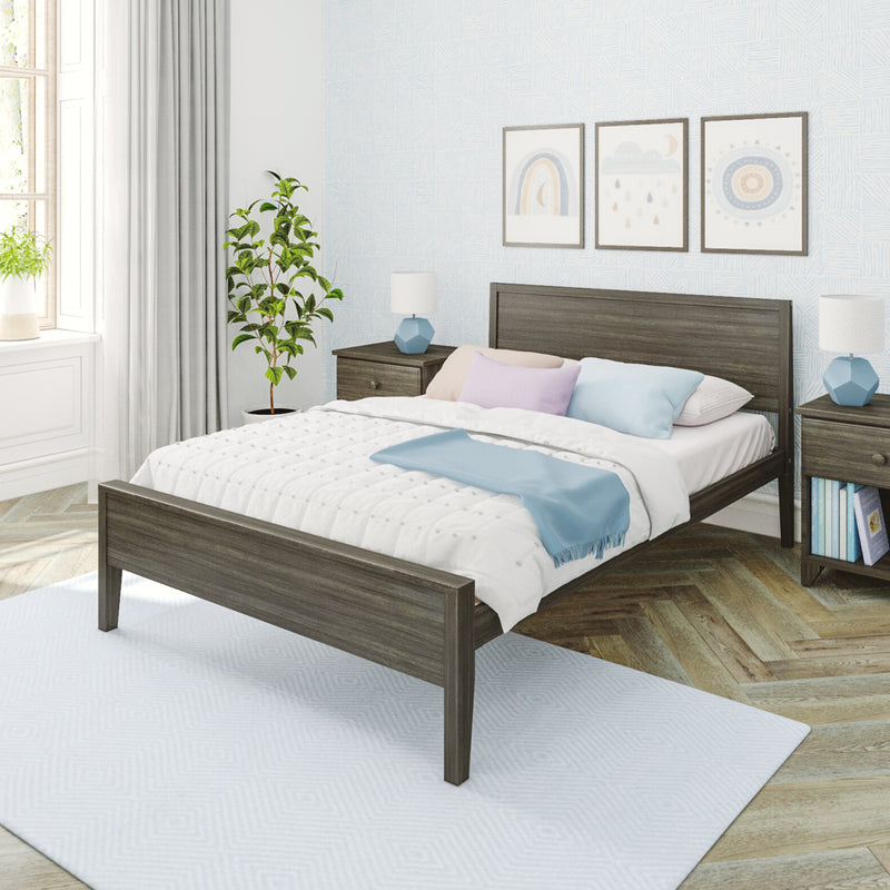 Modern cozy bedroom interior with gray wood bed frame, white quilt and pastel pillows, blue throw, matching nightstands and lamps, framed wall art, potted plant and natural window light