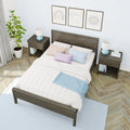 Modern light bedroom with dark wood bed frame, white quilt and pastel pillows, matching wood nightstands with blue geometric lamps, potted indoor plant, framed wall art, light blue patterned wallpaper and herringbone hardwood floor