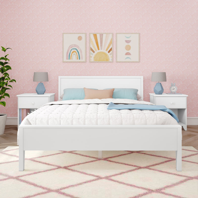 Pastel nursery with white bed, pink scallop wallpaper, framed rainbow and sun wall art, blue bedside lamps and pastel pillows