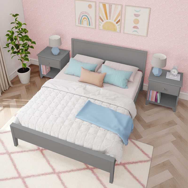 Girls bedroom with pink scallop wallpaper, gray bedframe, pastel pillows, matching nightstands, lamps and framed rainbow art