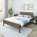 Modern bedroom with gray wood bed, white quilt, pastel pillows and blue throw, nightstands, framed wall art and potted plant