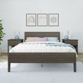 Modern nursery bedroom with dark wood platform bed, quilted white bedding, pastel pillows, blue geometric bedside lamps, patterned light-blue wallpaper and three framed rainbow and cloud prints