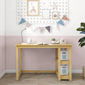 Kids' wooden study desk with white desk lamp, alarm clock, open book, succulent and storage boxes against pink half-wall with pegboard gallery and pastel bunting flags