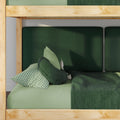 Close-up of wooden bunk bed with green bedding, gingham pillow and dark green upholstered headboard