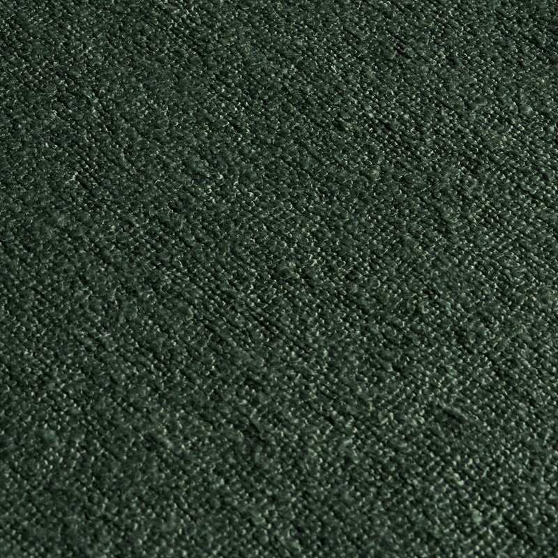 Close-up of dark green textured upholstery fabric, plush chenille boucle weave for sofas, cushions, and home decor