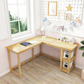 L-shaped natural wood corner desk in bright home office by window with pegboard, shelves, lamp and storage boxes