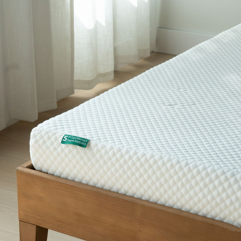 5-inch gel memory foam mattress with white quilted cover on wooden bed frame by sheer curtains in a sunlit bedroom