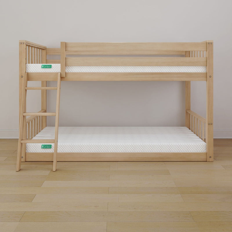 Wooden bunk bed with ladder and two white twin-size mattresses in a minimalist kids' bedroom, natural oak finish space-saving children's bunk bed for small rooms