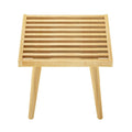Wooden slatted table with angled legs in natural finish.