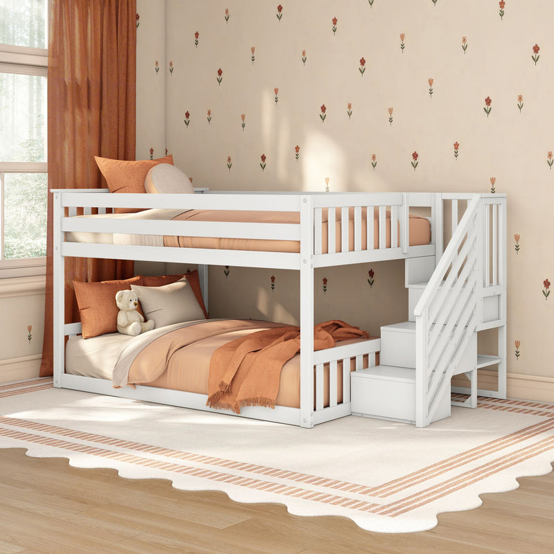 White kids bunk bed with stairs and storage in cozy children's bedroom with terracotta bedding, floral wallpaper, teddy bear and rug