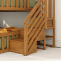 Solid wood bunk bed with built-in staircase and under-stair storage, natural oak finish with green mattress and mustard throw