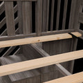 Close-up of weathered wood fence railing and light pine deck joists with metal support bracket – outdoor deck construction detail