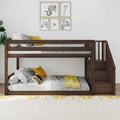 Modern dark-wood bunk bed with staircase in a children's bedroom, white bedding and yellow accent pillows, animal-themed framed wall art and cozy throw for nursery or kids' room décor