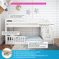 White wooden children's low-profile bunk bed with staircase storage and removable safety guardrail, blue striped bedding, moon and star wall decor, solid pine construction