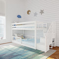White wooden bunk bed in bright kids' bedroom with striped rug, unicorn pillows and star, moon and cloud wall decor
