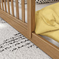 Close-up of solid oak slatted bed frame with white mattress and yellow duvet on black-and-white textured rug — modern wooden bed for farmhouse bedroom