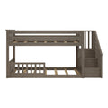 Gray wood twin-over-twin bunk bed with integrated staircase storage, slatted guardrails and space-saving loft design for kids’ bedroom furniture
