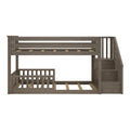 Gray wood twin-over-twin bunk bed with built-in staircase, slatted mattress platforms, safety guardrails and storage steps